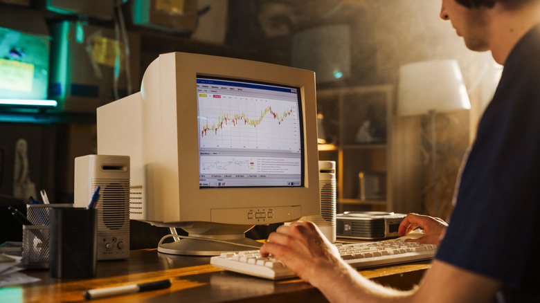 Someone using a desktop computer in the 90s with a retro CRT monitor.
