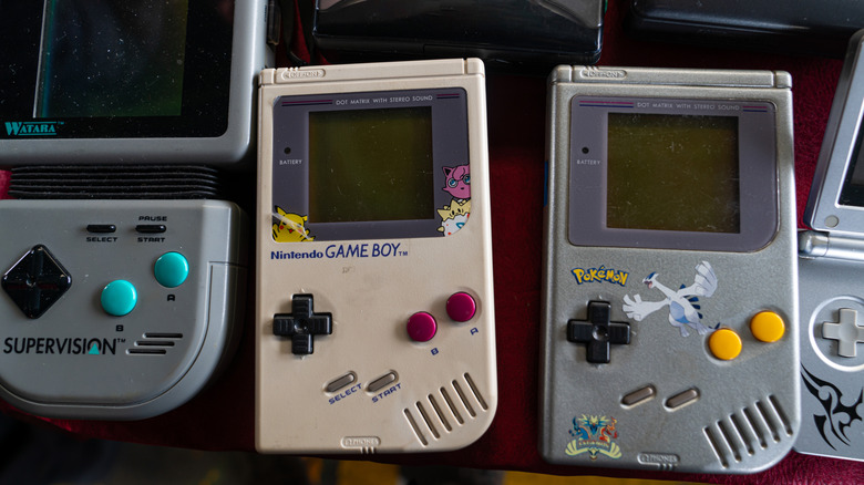 Different game boys in a flea market.