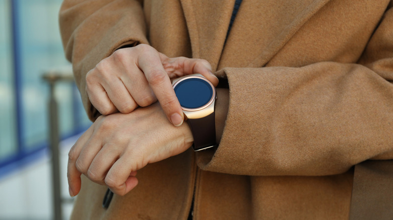 A person adjusting their smartwatch
