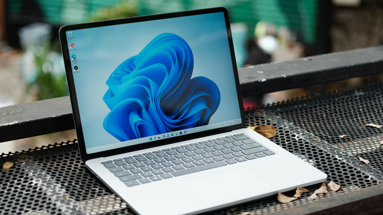 microsoft surface windows laptop placed outdoor on a metal grille