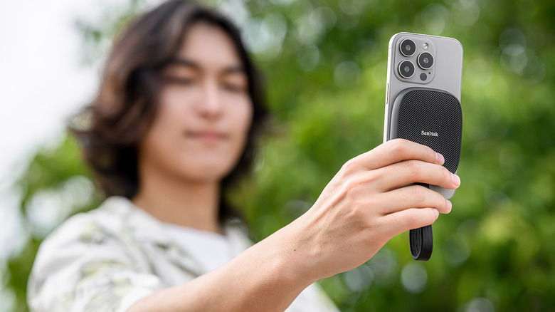 A person using their iPhone to click a photo with Sandisk Phone SSD