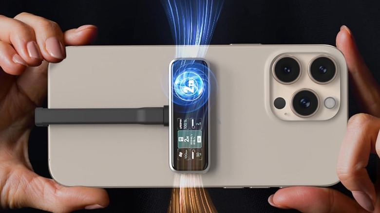 A phone being held horizontally, showing the ZIKE SSD connected to its back magnetically