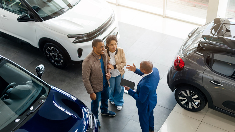 Two people shopping for a car at a dealership