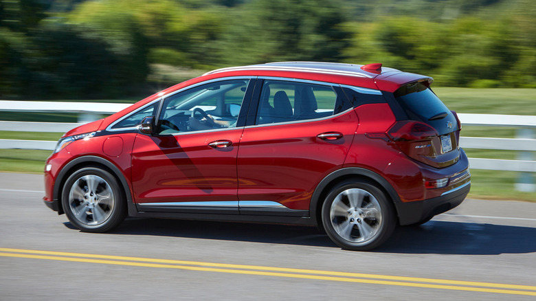 A red Chevrolet Bolt EV driving