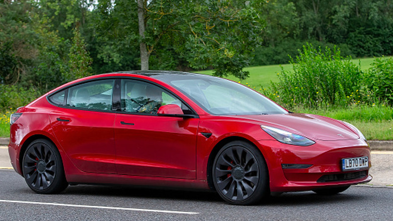 A 2020 red Tesla Model 3 Performance parked