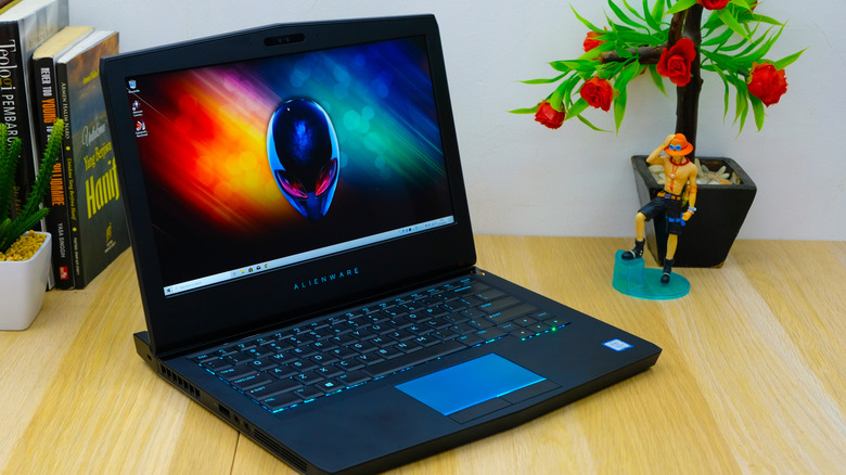 A powered on Alienware laptop placed on table top