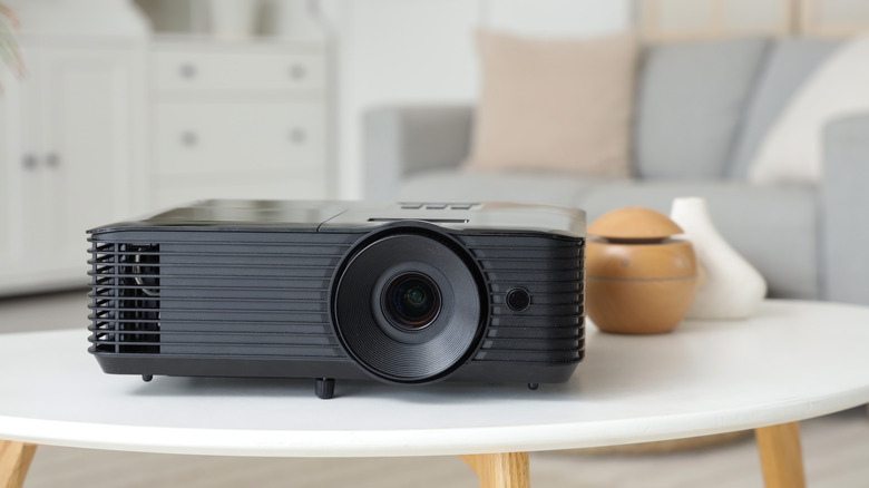 small projector on coffee table in simple living room