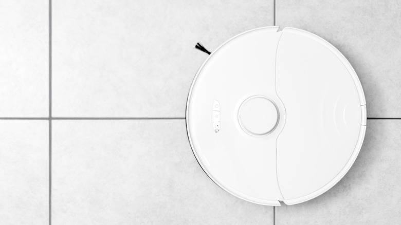 Robot vacuum cleaner is pictured on a tile floor.