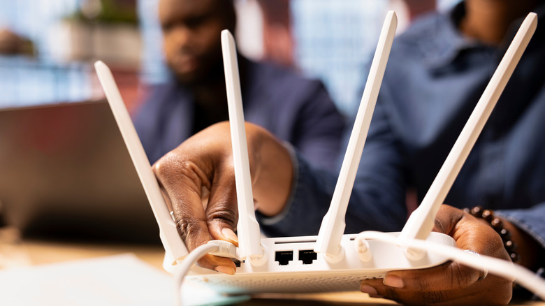 person rebooting a router