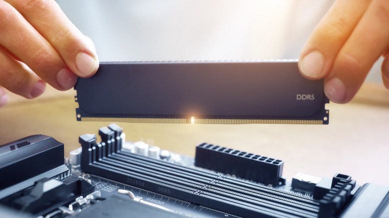 A person installing DDR5 RAM