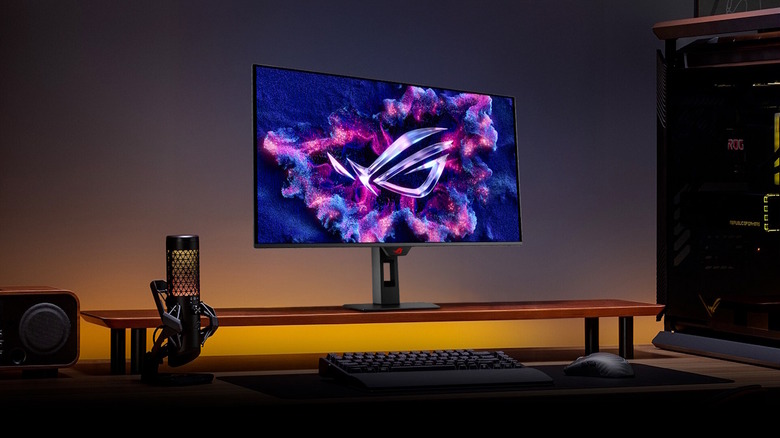 Asus ROG Strix XG32UCDS 4K Monitor on a monitor stand as part of a computer setup