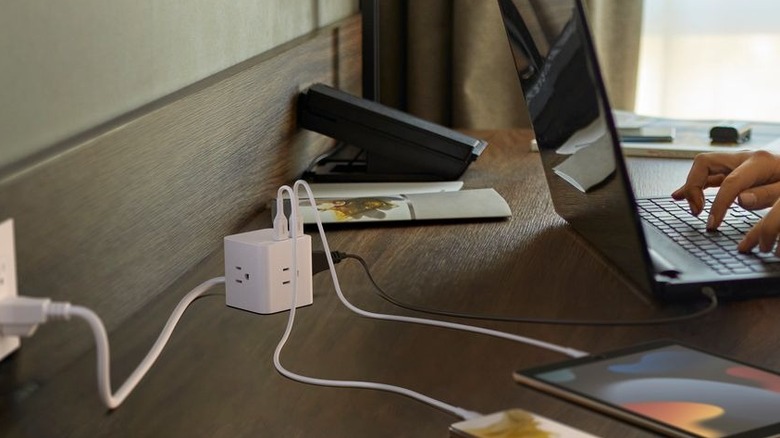 Belkin Power Cube on table connected to phone, tablet, and laptop