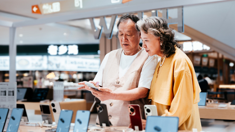 A couple selecting a smartphone in a store