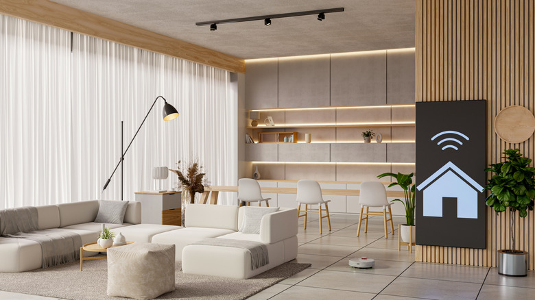 The living room of a modern home with wood paneling and sleek surfaces.
