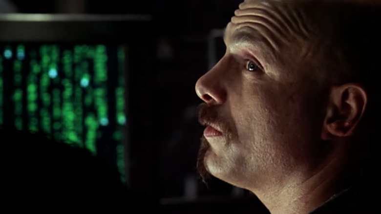 Cypher looking to his left in "The Matrix"