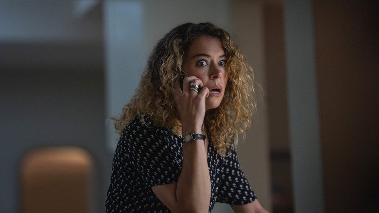 A wide-eyed Paula (Tatiana Maslany) looks terrified as she answers the phone in Maximum Pleasure Guaranteed