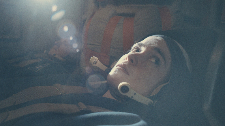 Anastasia (Alice Englert), in a cosmonaut suit, looks off into the distance as she readies for take off in Star City