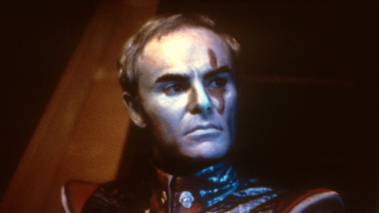 Sador (John Saxon) standing in a dark room in "Battle Beyond the Stars."