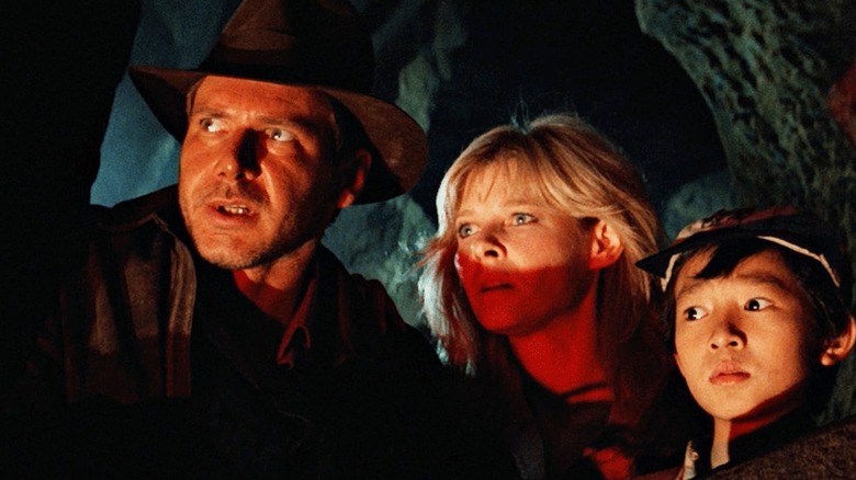 Indiana Jones, Willie, and Short Round looking scared in Indiana Jones and the Temple of Doom