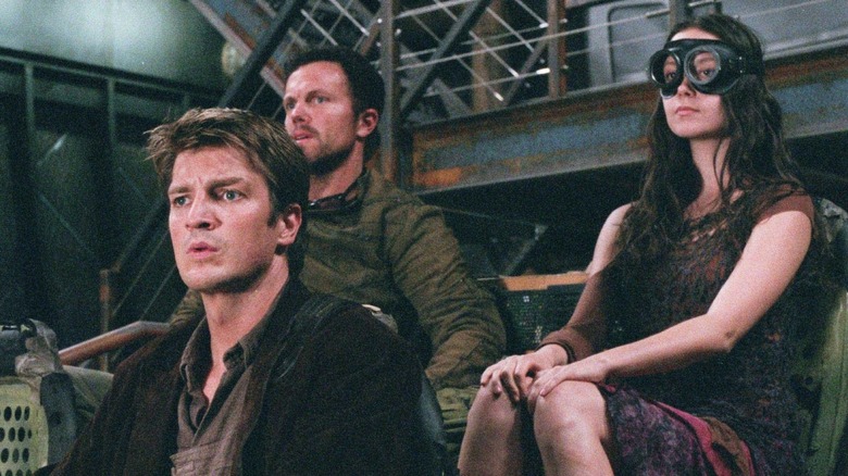 Mal, Jayne, and River on a cart in Serenity