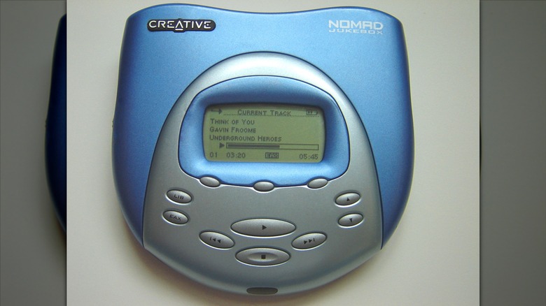 The original Creative Nomad Jukebox is silver and blue, its LCD screen is showing information about a song