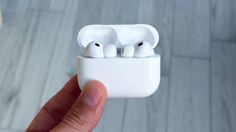A hand holding Apple's AirPods Pro 3