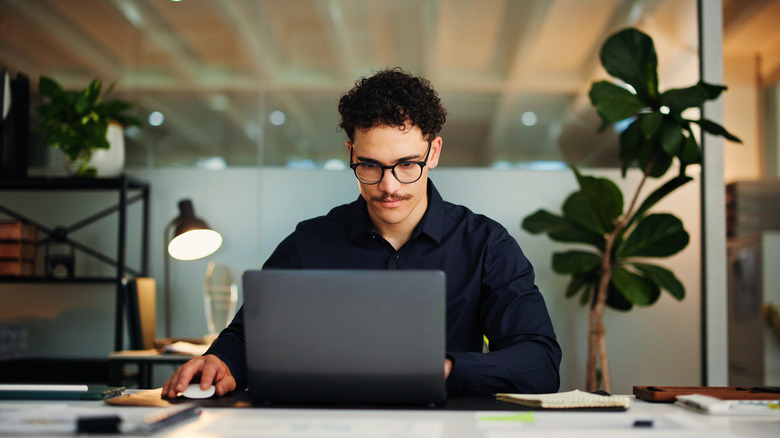 A person using a computer in an office setting.