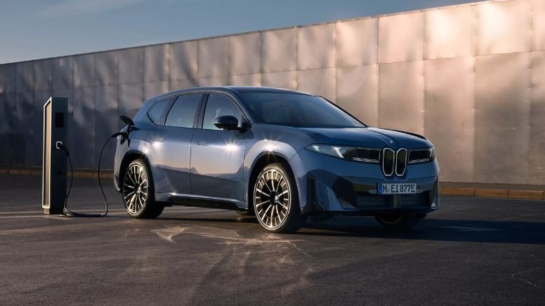 2026 BMW iX3 charging in front of metal panels