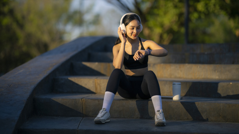 A person looking at a smartwatch while exercising.