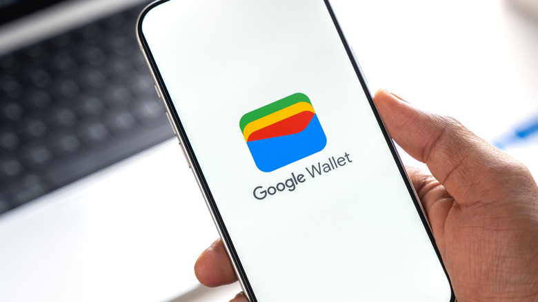 Man holding a phone displaying the Google Wallet Logo