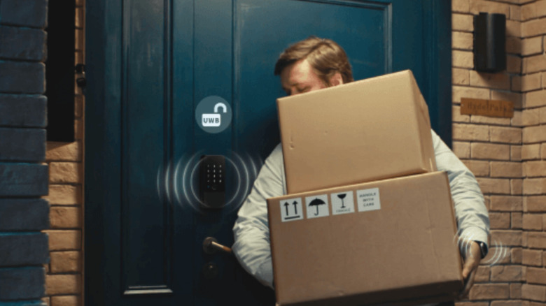 A man unlocking his door with his iPhone thanks to Aqara's smart lock with ultra-wideband compatibility
