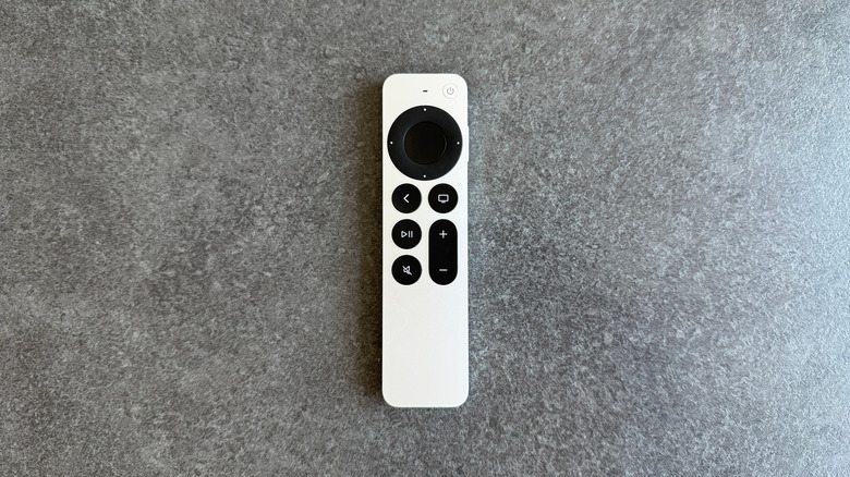 Apple TV remote on a grey background