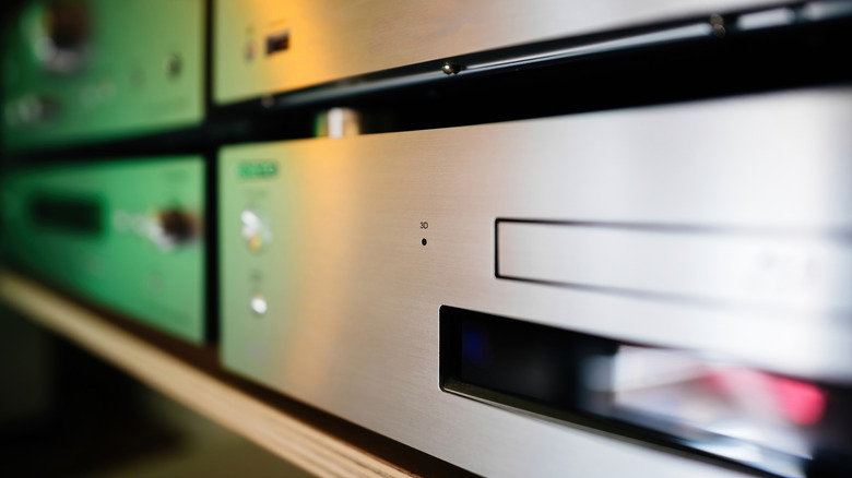 Stacked Blu-ray players with silver brushed metal exteriors.