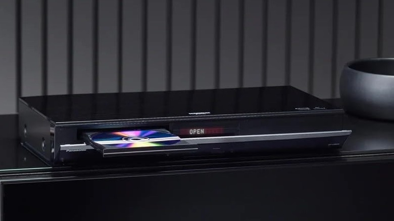 A Blu-ray player stands with its drive open on a side stand.