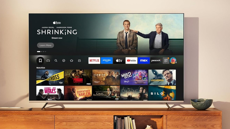 The Hisense QD7QF on an entertainment center in a modern living room.