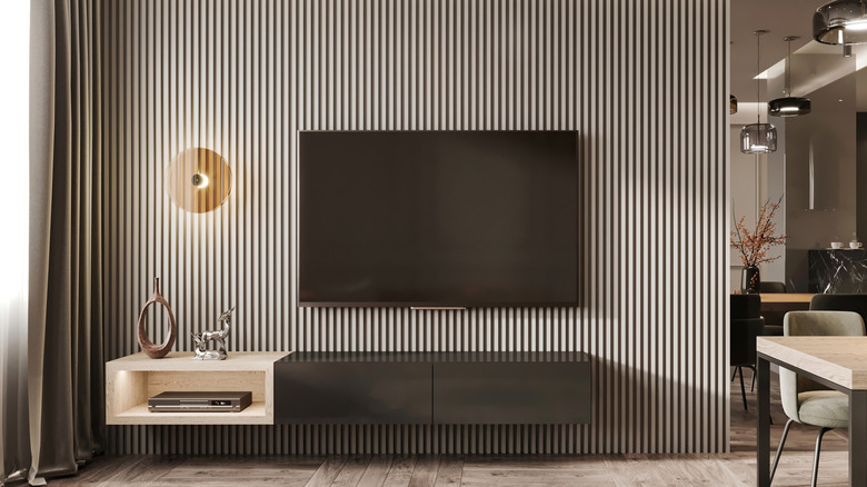 A wall-mounted TV in a bright and spacious living room.