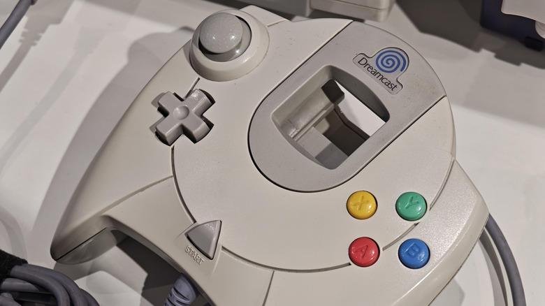 Sega Dreamcast controller on top of console