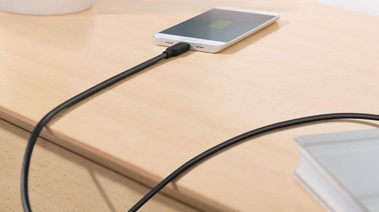 Anker Powerline II cable connected to a phone placed on wooden desk