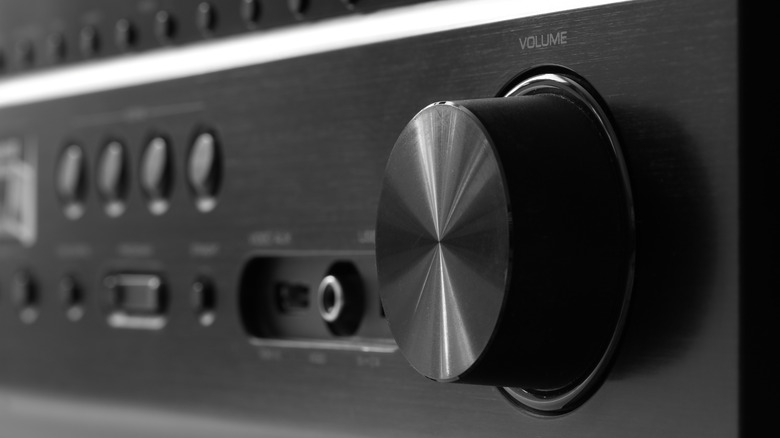 The front of an AV receiver with a large volume dial.