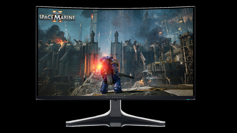 Alienware AW3225QF curved gaming monitor displaying Warhammer 4K: Space Marine 2 on a black background.