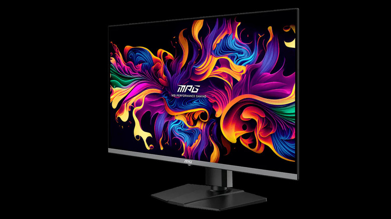MSI MPG 321URX gaming monitor displaying a colorful abstract image on a black background.