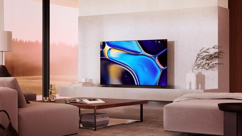 The Sony 77-inch Bravia 8 OLED placed on a chic TV stand in a modern living room.