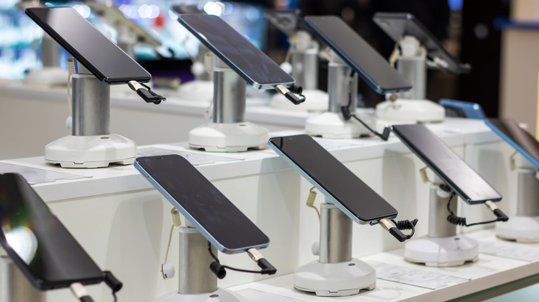 A row of mobile phones in a shop.