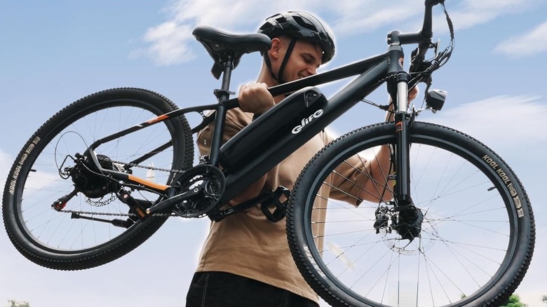 Man holding Qlife Racer Electric Bike for Adults