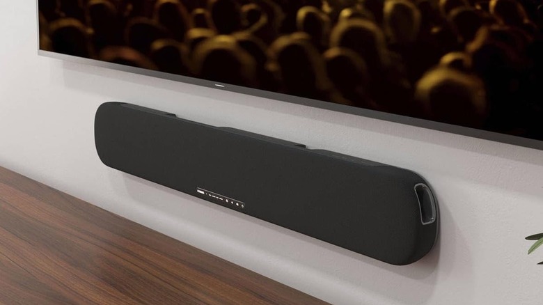 The Yamaha SR-B20A mounted to the wall below a wall-mounted TV.