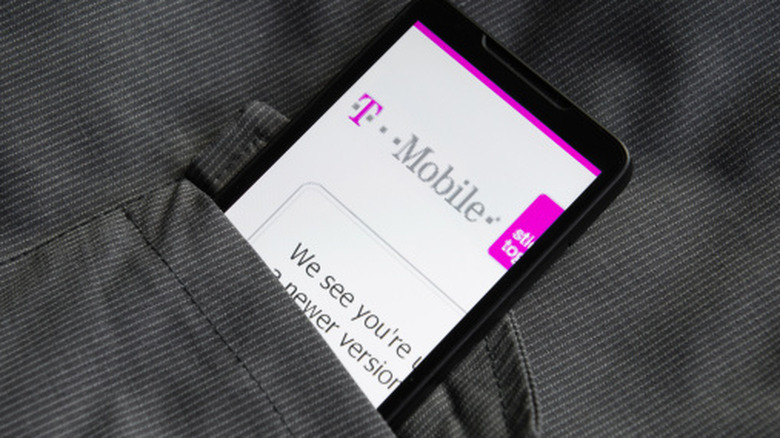 Smartphone showing a T-Mobile page while tucked into a gray pocket.