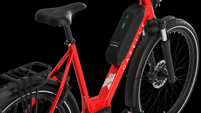 a red and black Gazelle e-bike on a black background.