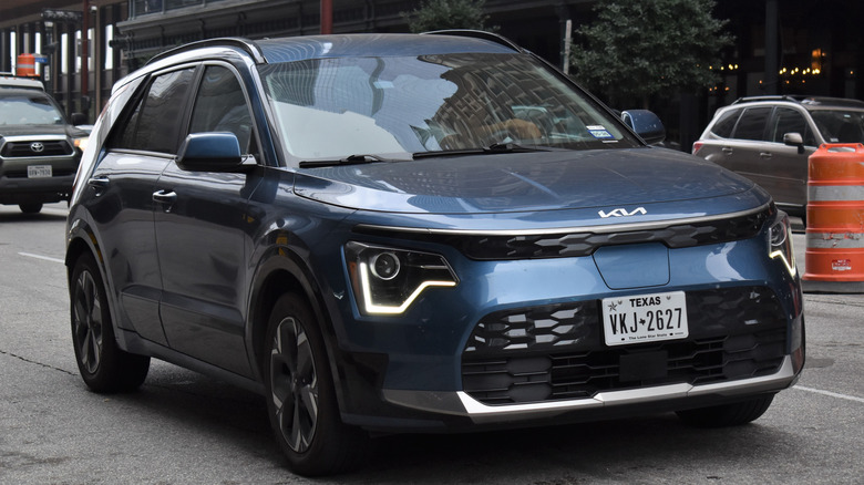 A dark blue Kia Niro EV on a road