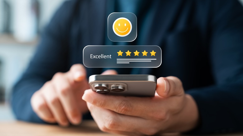 A person holding an iPhone in their hand.