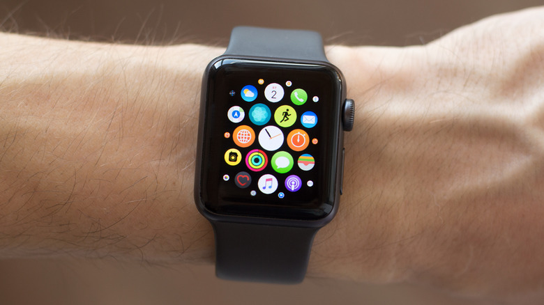A closeup an Apple Watch with a black band on a writst